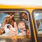 Photo: Students give thumbs up from the bus