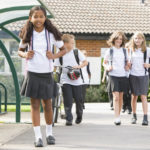 Photo: Private school students approaching the bus stop